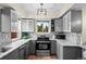 Modern kitchen features gray cabinets, granite countertops, stainless steel appliances, and mosaic backsplash at 435 Balsam St, Lakewood, CO 80226