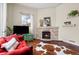 Cozy living room with a fireplace, rich hardwood floors, and lots of natural light at 435 Balsam St, Lakewood, CO 80226
