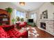 Bright and cozy living room with hardwood floors, a stone fireplace, and stylish furnishings at 435 Balsam St, Lakewood, CO 80226