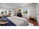 Bright main bedroom featuring hardwood floors, a large window, and comfortable seating area for relaxation at 435 Balsam St, Lakewood, CO 80226