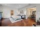 This main bedroom has hardwood floors, a picture window, and an ensuite bathroom for comfort and convenience at 435 Balsam St, Lakewood, CO 80226