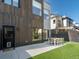 This backyard features a dining set on the patio and artificial turf at 4432 Umatilla St, Denver, CO 80211