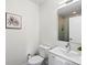 Modern bathroom with stylish vanity, mirror, updated fixtures, and glass-enclosed shower at 4432 Umatilla St, Denver, CO 80211