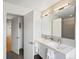 Modern bathroom showcasing double sinks, sleek fixtures, and a view to the shower and hallway at 4432 Umatilla St, Denver, CO 80211