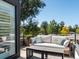 Outdoor deck features a comfortable sofa, stylish pillows, and a small coffee table at 4432 Umatilla St, Denver, CO 80211
