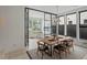 Bright dining room featuring a wooden table, statement light fixture, and seamless transition to an office at 4432 Umatilla St, Denver, CO 80211