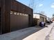 Modern garage exterior with a large brown door and a concrete driveway, providing convenient parking at 4432 Umatilla St, Denver, CO 80211