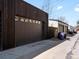 View of the garages with dark brown doors at 4432 Umatilla St, Denver, CO 80211