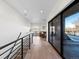 Hallway with stairs, leading to living space with a sofa, wet bar and sliding doors to deck at 4432 Umatilla St, Denver, CO 80211