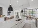 Well-designed kitchen with a large island, quartz countertops, stainless steel appliances, and open concept layout at 4432 Umatilla St, Denver, CO 80211