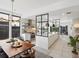 Elegant kitchen with large island, dining area, modern appliances, and stylish pendant lighting, perfect for entertaining at 4432 Umatilla St, Denver, CO 80211