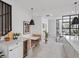 Stylish kitchen with a built-in breakfast nook, wine cooler, modern lighting, and seamless flow to living spaces at 4432 Umatilla St, Denver, CO 80211