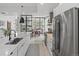 Modern kitchen with stainless appliances, quartz countertops, and a seamless flow to the dining and living areas at 4432 Umatilla St, Denver, CO 80211