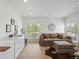 Relaxing living room featuring a wet bar, wine fridge, sofa, and ottoman at 4432 Umatilla St, Denver, CO 80211