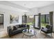 Bright living room featuring modern decor, stylish furniture, and seamless indoor/outdoor flow to a private patio at 4432 Umatilla St, Denver, CO 80211