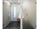 Glass enclosed shower featuring tiled walls, overhead shower head, and seating at 4432 Umatilla St, Denver, CO 80211