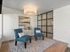 Cozy sitting area with stylish chairs, a decorative bar cart, and ambient lighting for a relaxing retreat at 4432 Umatilla St, Denver, CO 80211