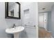 Powder room features a pedestal sink, bright blue walls and tile floors at 1929 S Xanadu Way, Aurora, CO 80014