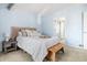 Bedroom with woven headboard and ensuite bathroom at 1929 S Xanadu Way, Aurora, CO 80014