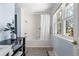 Bathroom features a tub with shower, light blue walls and a window for natural light at 1929 S Xanadu Way, Aurora, CO 80014