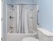 All-white bathroom with shower and bathtub, plus white tile and bright blue walls at 1929 S Xanadu Way, Aurora, CO 80014