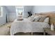 Bright bedroom with light blue walls, woven headboard and sitting area with a window at 1929 S Xanadu Way, Aurora, CO 80014