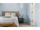 Bedroom with woven headboard, side table, and light blue walls at 1929 S Xanadu Way, Aurora, CO 80014