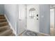 Bright entryway featuring carpeted stairs, tile flooring and a front door with decorative glass at 1929 S Xanadu Way, Aurora, CO 80014