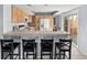 A kitchen featuring bar-top seating, a tile countertop and a sliding glass door with backyard views at 1929 S Xanadu Way, Aurora, CO 80014