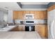 Kitchen with light wood cabinets, tile countertops, ample storage, and modern appliances at 1929 S Xanadu Way, Aurora, CO 80014