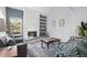 Comfortable living room featuring a stone fireplace and built-in shelving, perfect for relaxation at 1929 S Xanadu Way, Aurora, CO 80014