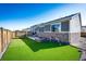 Wonderful backyard features an outdoor fire pit, artificial turf, and a trampoline at 469 S Olathe St, Aurora, CO 80017