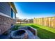 This backyard features a gorgeous firepit area and stunning artificial turf grass at 469 S Olathe St, Aurora, CO 80017