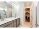 Bathroom featuring double sinks, a large mirror and a walk in shower at 469 S Olathe St, Aurora, CO 80017