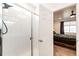 Bathroom featuring an open door that leads to a bedroom with a ceiling fan and a walk in shower at 469 S Olathe St, Aurora, CO 80017