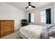 Cozy bedroom featuring a comfortable bed, natural light from windows, and a ceiling fan at 469 S Olathe St, Aurora, CO 80017