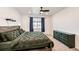 Bedroom with wood frame bed, ceiling fan, and chest of drawers at 469 S Olathe St, Aurora, CO 80017