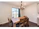 Charming dining area with a rustic wood table, chandelier, and natural light at 469 S Olathe St, Aurora, CO 80017