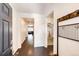 Inviting entryway with dark wood floors, coat rack, and views into other rooms of the home at 469 S Olathe St, Aurora, CO 80017