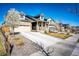 Beautiful home with a large driveway, stone accents, and flowering trees in a well-maintained neighborhood at 469 S Olathe St, Aurora, CO 80017
