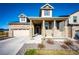 Charming home showcasing stone accents, a covered front porch, and a well-manicured lawn on a sunny day at 469 S Olathe St, Aurora, CO 80017
