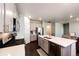 Bright kitchen with gas range, stainless appliances, island with seating, and light gray cabinets at 469 S Olathe St, Aurora, CO 80017