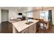 Open concept kitchen and living area with quartz island, stainless appliances and hardwood floors at 469 S Olathe St, Aurora, CO 80017