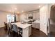 Bright kitchen with an island, gray cabinets, stainless steel appliances, and a breakfast bar at 469 S Olathe St, Aurora, CO 80017
