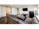 Spacious living room with dark hardwood floors, a comfortable gray sectional, and a mounted TV at 469 S Olathe St, Aurora, CO 80017
