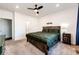 Comfortable bedroom featuring a wooden bed frame, ceiling fan, and neutral carpet at 469 S Olathe St, Aurora, CO 80017