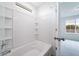 Clean bathroom features a white tiled shower and bathtub combo, offering a refreshing space at 22133 E 38Th Pl, Aurora, CO 80019