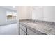 This bathroom features a gray vanity with granite countertops and modern fixtures at 22133 E 38Th Pl, Aurora, CO 80019