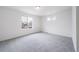 Bright bedroom features a large window and neutral carpet, offering a comfortable living space at 22133 E 38Th Pl, Aurora, CO 80019