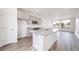 Bright kitchen features a granite island, stainless steel sink, and ample natural light at 22133 E 38Th Pl, Aurora, CO 80019